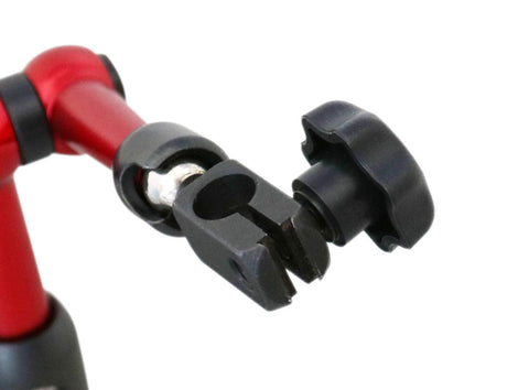 Dial indicator stand clamp arm with black adjustable jaw and knob on a red tube, close-up