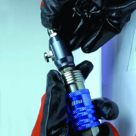 5-In-1 Universal Safety Air Coupler With 0.25 Inch Female Thread held by black gloves during installation