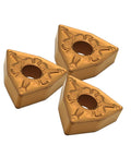 Three gold triangular carbide turning inserts with center hole for steel machining.