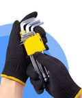 Daily Grind Gear Twelve Pair Pack Of Flexible Polyester Knit Work Gloves featuring black and yellow trim, holding tools.