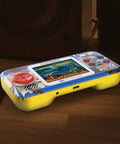 Street Fighter II Pocket Player Pro Handheld Console 2 In 1 Capcom Licensed Classics with color display on wooden surface
