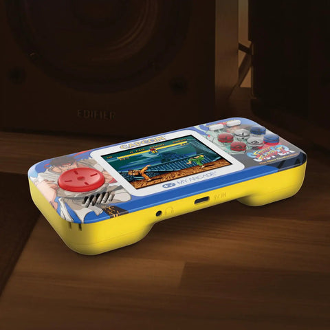 Street Fighter II Pocket Player Pro Handheld Console 2 In 1 Capcom Licensed Classics with color display on wooden surface