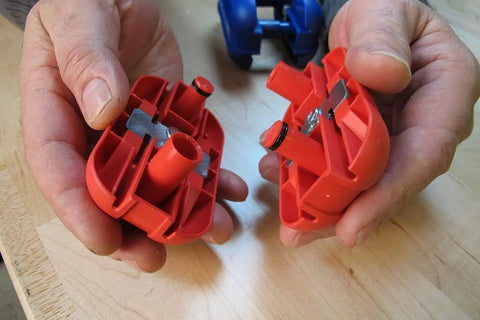 Hands holding dismantled parts of Pneumatic Quad Trimmer With 30 Degree Carbon Steel Blade No Springs Attached Ergonomic Handheld Design.