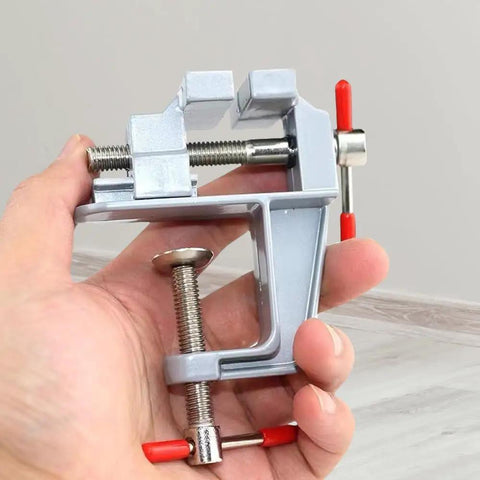 Reliable Mini Bench Vise With Quick Release Table Clamp And Drill Press Mount Holds Rock Solid for Jewelry Watch Fixing in hand.
