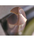 Close-up of WEXWE chamfer end mill tip, two flutes, copper-colored carbide cutting edge.