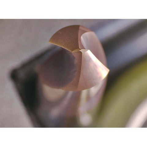 Close-up of WEXWE chamfer end mill tip, two flutes, copper-colored carbide cutting edge.