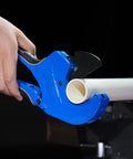 Pacmann blue PVC pipe cutter cutting a white PVC pipe up to 2-1/2 in with ratchet blade