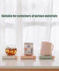 Electric Coffee Mug Warmer For Office Desk With Auto Shut Off Timer Keep Your Brew Piping Hot Straight Up Skip The Microwave Hassle Flat Bottom Cup Heater For Tea Coffee Milk And Quick Sips on a desk with a glass cup, carton, and mug.