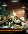 Family dining under 12 Pack Daylight 6000K E12 LED Bulbs for Chandeliers, enjoying bright white lighting.