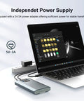 Independent power supply for Killer Dual Bay M.2 NVMe RAID Enclosure with 5V/3A adapter connected to laptop.
