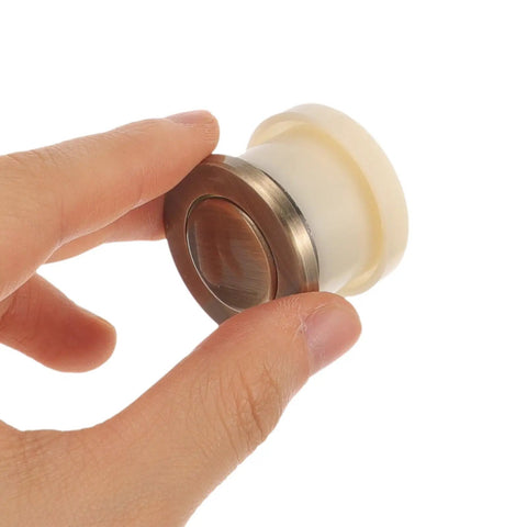 Close-up of Vintage Metal Spring Loaded Push To Open Cabinet Knobs No Visible Screws Invisible Mount Round Wardrobe Handles