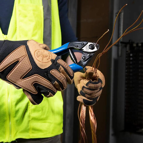 Worker using Beefy Heavy Duty Cable Cutter for ACSR and Hardened Wire Center Cut Jaws, cutting wires with locking handles and precision blades
