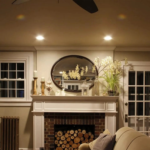 Living room with 12 Pack 4 Inch LED Can Lights With Night Light, Dimmable Damp Rated Recessed Kit illuminating fireplace area