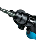 Side view of a blue and black SDS-Plus rotary hammer drill with carbide-tipped drill bit installed