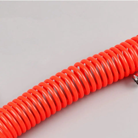 Hella Durable Coiled Air Compressor Hose Built Damn Tough With Single Layer Polyurethane showing bright red coiled tubing with fittings.