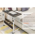 Height Adjustable Mobile Laptop Desk Sets The Chill Vibe For Remote Work Sessions While Rolling On Slick Casters And Locks Down Tight For Ultimate Stability with a sleek black top.