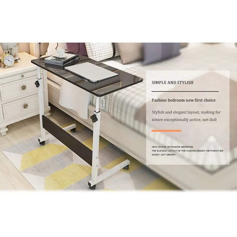 Height Adjustable Mobile Laptop Desk Featuring Smooth Glide Casters And Secure Lock Brakes For Flex Angle Adjustments and Kick Back Living Room Or Home Office Ease positioned beside a bed.