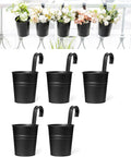 5 Pack 4 Inch Hanging Flower Pots Metal Dope Planters For Railing Fence Balcony And Garden Outdoor Decor With Detachable Hooks Ideal For Herb And Flower Gardens In Black shown on railing with flowers and detached