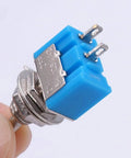 Close-up of SPST Mini Toggle Switch 2 Pin 2 Position On Off 6A 125V Latching Toggle Switch MTS101 with blue and silver metal body