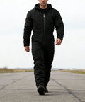 Mens Heavy Duty Canvas Work Jumpsuit With Thermal Hood And Full Zip Front Insulated Coveralls For Construction Trades, walking on a runway.