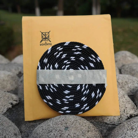 Durable Sageo Wrapping Cord For Katana Wakizashi Tanto Dope Black And White Synthetic Silk on stone background