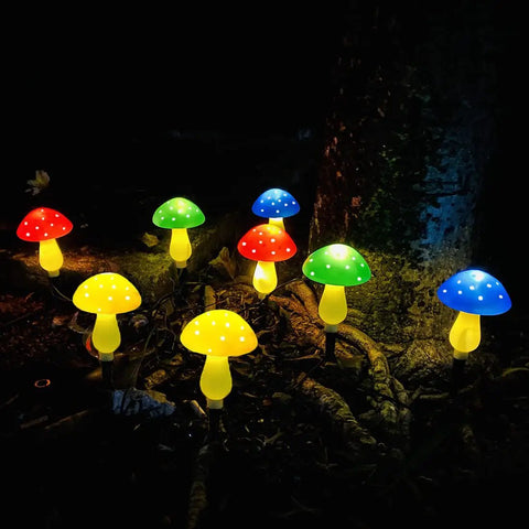 Upgraded Dope Solar Mushroom Lights For Outdoors And Garden Decor with multicolor LEDs illuminating a garden at night.