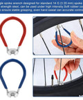 Red and blue spoke wrenches in use on a bicycle wheel from the Eight Piece Bike Spoke Wrench Tool Kit For Rim Truing And Tire Levers