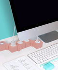 Pink Power Strip With Surge Protection, 3 AC Outlets And 2 USB Ports, Flexible Twist Design For Desk Or Floor, next to monitor on desk