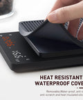 Silicone cover being lifted on a Precision Coffee Scale With Timer For Pour Over And Espresso, 0.1g High Precision Kitchen Scale
