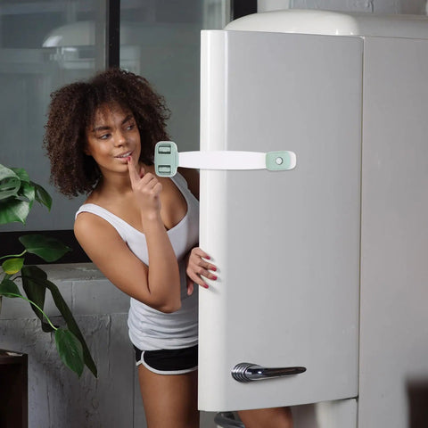 Woman standing near fridge secured with kid safe cabinet door and drawer latches with double press buckle design ABS material.