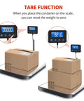 Heavy Duty 440Lb Shipping Scale For Packages And Postage with stainless steel surface showing tare function with boxes