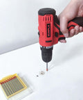Side view of Gunpla cordless drill with 6mm masonry bit; red and black tool with yellow bit set visible.