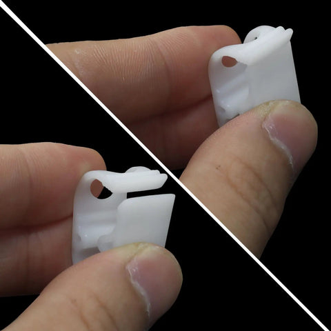 Close-up of a hand holding a 20 Piece Plastic Tubing Clamps For 1/8 To 1/4 Inch Tubing, Adjustable Hose Shut Off Clamps in white plastic.