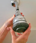 Person installing Wall Mounted Water Filtered Shower Head with Massage in Chrome Finish Reduces Chlorine and Sulfur Odor Softens Skin and Hair Up To 6 Months Filter Life or 10000 Gallons Easy Install.