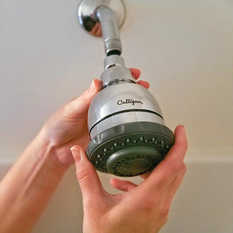 Person installing Wall Mounted Water Filtered Shower Head with Massage in Chrome Finish Reduces Chlorine and Sulfur Odor Softens Skin and Hair Up To 6 Months Filter Life or 10000 Gallons Easy Install.