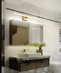Gold 24 Inch Dimmable LED Vanity Light for Bathroom Over Mirror, shown installed above a bathroom mirror in a modern setting.
