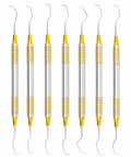 Gracey Curettes Set 7 Pcs With Gold Plasma Coated Tips For Precision Scaling Root Planing And Periodontal Care, Ergonomic 9 Mm Handle For A Comfy Pro Grade Dental Instrument Kit. Seven dental curettes on white background.