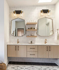 2 Light Vanity Light Fixture Black and Gold With Clear Glass Shade Matte Black Finish Brushed Gold Copper Accent Socket Modern Over Mirror Bathroom Wall Sconce For Bathrooms in a modern bathroom setting