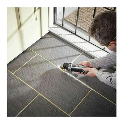 5 Amp Tool-Less Oscillating Tool Kit With Accessory Set For Cutting Sanding Grinding And Scraping in use on floor tiles