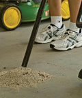 Person using All Purpose Ash Vacuum For Fireplaces And Grills With 10 Amp Power to clean ash from a garage floor
