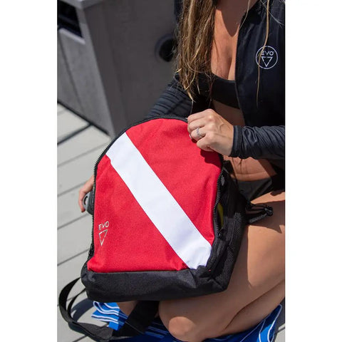 Durable Scuba Regulator Bag With Padded Compartment on deck with woman holding, red and black design, ready for dive gear storage