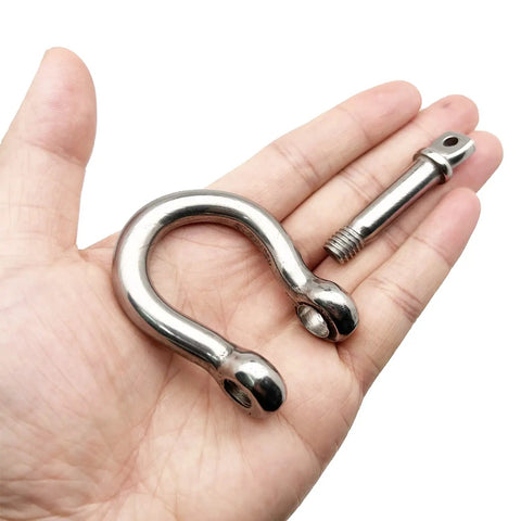 Two Pack Three Eighth Inch Screw Pin Anchor Shackle Premium 304 Stainless Steel, heavy duty rigging in hand.