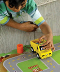 Switcheroo Coding Crew Screen Free Robot Kit For Kids Hands On Push Button Coding To Learn Sequencing Logic And Problem Solving Through Rescue Mission Play And Totally Imaginative STEM Adventures, child using yellow robot truck