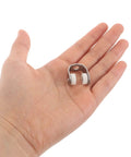 Hand holding Heavy Duty Metal Sliding Door Rollers With Track Wheels 25 Pcs Set For Heavy Doors And Window Curtains.