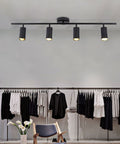 Four Light Black Track Lighting Kit With Flexible Heads Dimmable LED Indoor Ceiling Spotlight in a modern room setting