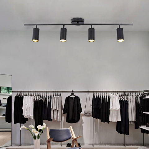 Four Light Black Track Lighting Kit With Flexible Heads Dimmable LED Indoor Ceiling Spotlight in a modern room setting