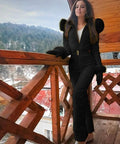 Woman wearing All Weather One Piece Snow Suit For Women And Men Waterproof Windproof Insulated Ski Jumpsuit For Snow Sports Black XL on balcony.