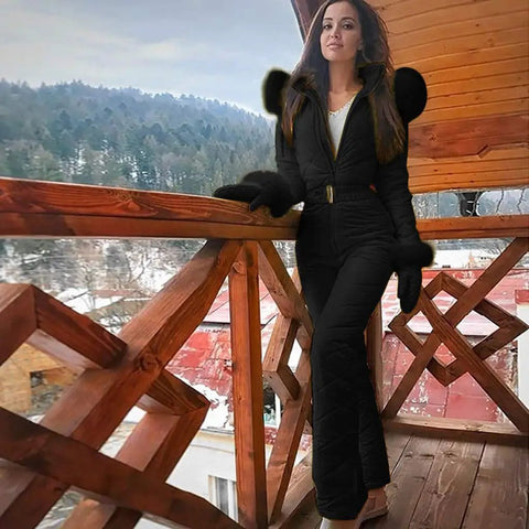 Woman wearing All Weather One Piece Snow Suit For Women And Men Waterproof Windproof Insulated Ski Jumpsuit For Snow Sports Black XL on balcony.