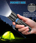 Person holding Beast Mode 2000 Lumen Rechargeable LED Flashlight Tactical Torch With Clip during camping at night.