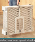 Person holding folded Six Panel Petyard Passage Dog Playpen Fence with Wall Mount Kit, portable and light gray